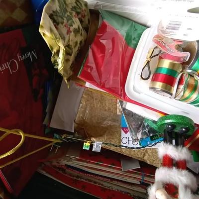 LOT 114 TWO NUTCRACKERS AND CONTAINER FULL OF WRAPPING SUPPLIES