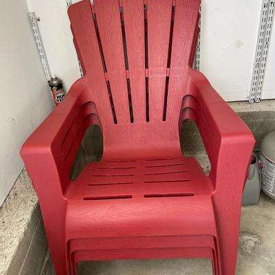 3 red resin Adirondack chairs