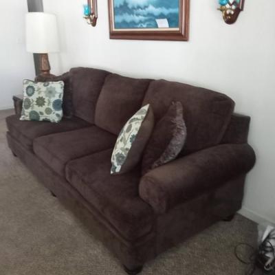 LOT 10  DARK BROWN SOFA WITH THROW PILLOWS  (Front room)