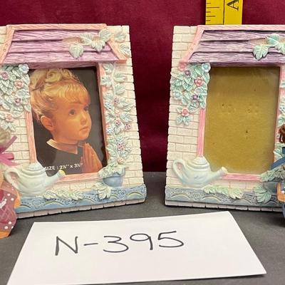 2 picture frames and 2 wooden dolls