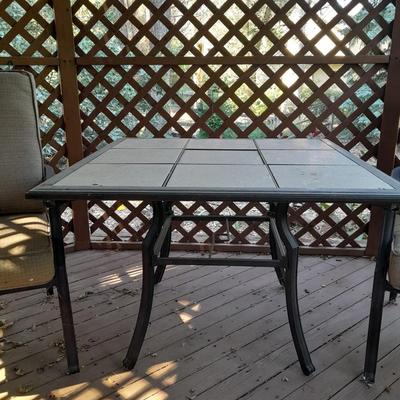 LOT 25 TWO PATIO CHAIRS AND TILE TOPPED PATIO TABLE