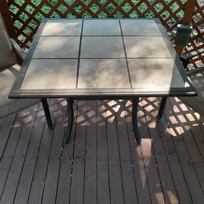 LOT 26 TWO PATIO CHAIRS AND TILE TOPPED PATIO TABLE