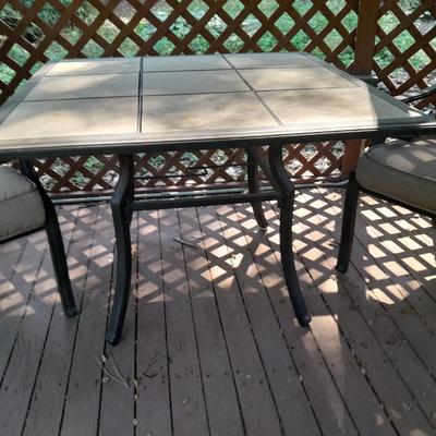 LOT 26 TWO PATIO CHAIRS AND TILE TOPPED PATIO TABLE
