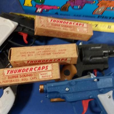 LOT 152  BOX TOY CAP GUNS AND CAPS