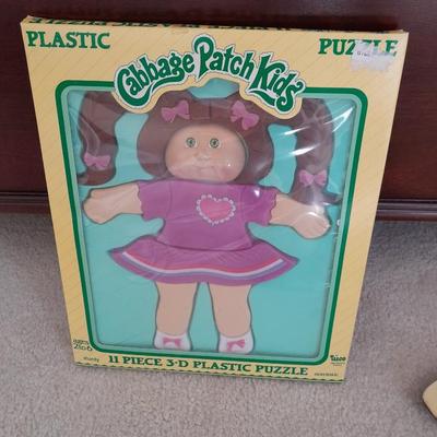 LOT 117 CABBAGE PATCH KIDS PLASTIC PUZZLE AND PLASTIC HANGING ROCKING HORSE