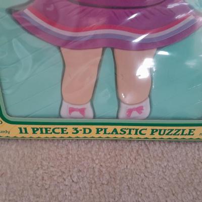LOT 117 CABBAGE PATCH KIDS PLASTIC PUZZLE AND PLASTIC HANGING ROCKING HORSE