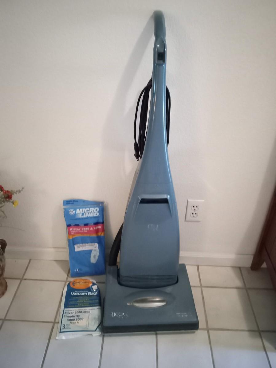 LOT 4 RICCAR VACUUM CLEANER WITH EXTRA BAGS (Entry way closet