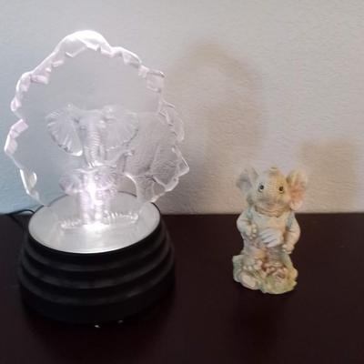 LOT 107  GLASS ELEPHANTS ON A MULTI COLORED PRISM AND A CERAMIC ELEPHANT (1st Bdr)