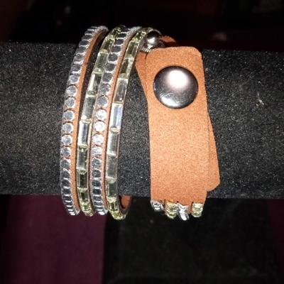 LOT 28  TWO LEATHER MULTI BAND BRACELETS WITHACCENTS