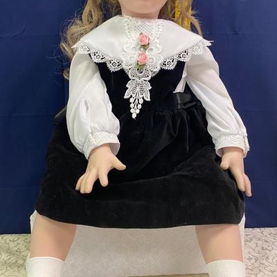 Sitting Doll in Black Dress