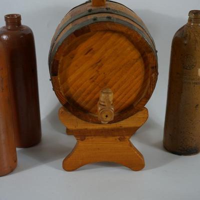 SMALL WOODEN BARRELL W/ THREE STONEWARE BOTTLES GROUPING.