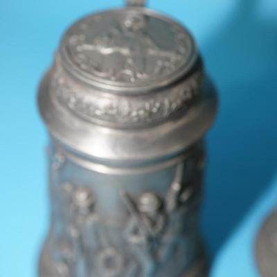 ANTIQUE GERMAN HEAVY RELIEF STEINS. OPEN WING ANGEL HALLMARK ON TWO.