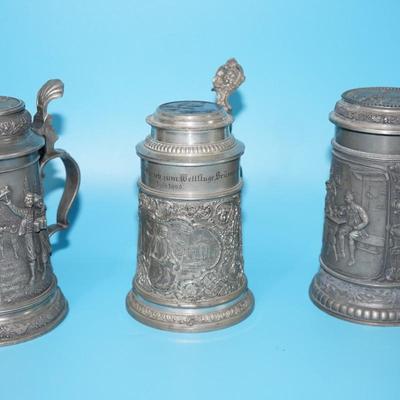 ANTIQUE GERMAN HEAVY RELIEF STEINS. OPEN WING ANGEL HALLMARK ON TWO.
