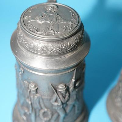 ANTIQUE GERMAN HEAVY RELIEF STEINS. OPEN WING ANGEL HALLMARK ON TWO.