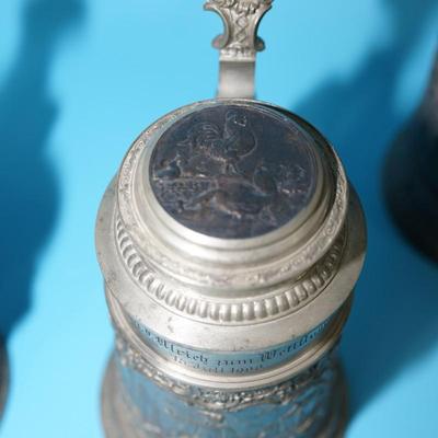 ANTIQUE GERMAN HEAVY RELIEF STEINS. OPEN WING ANGEL HALLMARK ON TWO.