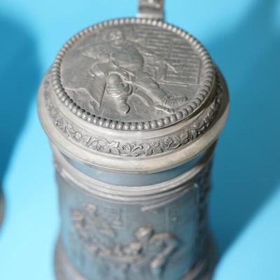 ANTIQUE GERMAN HEAVY RELIEF STEINS. OPEN WING ANGEL HALLMARK ON TWO.