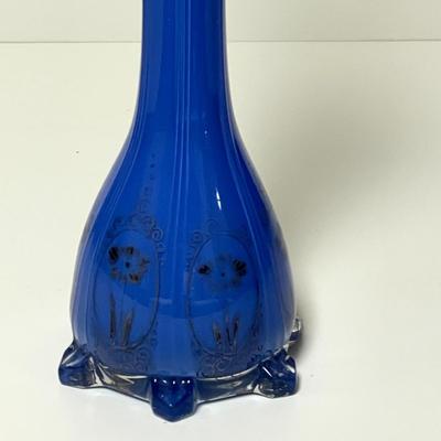 LOT 99  CASED BLUE GLASS BUD VASE PAINTED DESIGN.