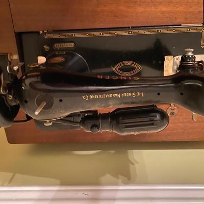 Antique Singer sewing machine in cabinet