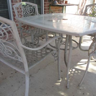Tan Glasstop Patio Table and Chairs