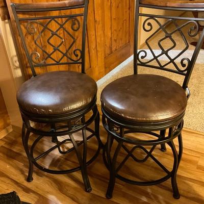 Two counter height swivel stools
