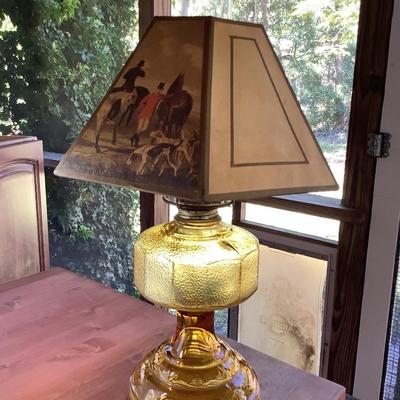 Amber glass oil lamp with equestrian shade