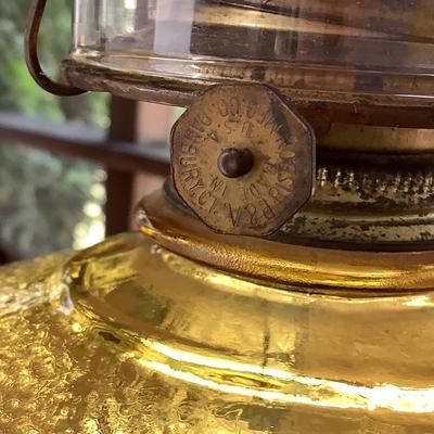Amber glass oil lamp with equestrian shade