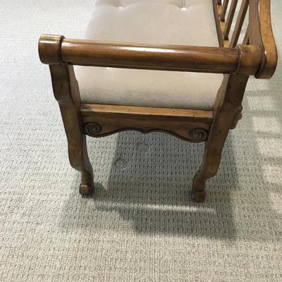 Carved wood bench with upholstered seat