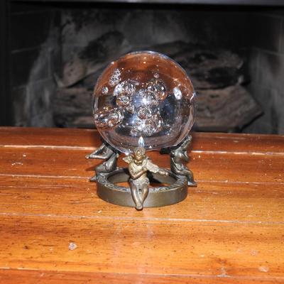 Crystal ball sitting on a stand of cherubs