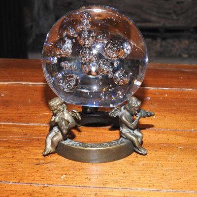 Crystal ball sitting on a stand of cherubs