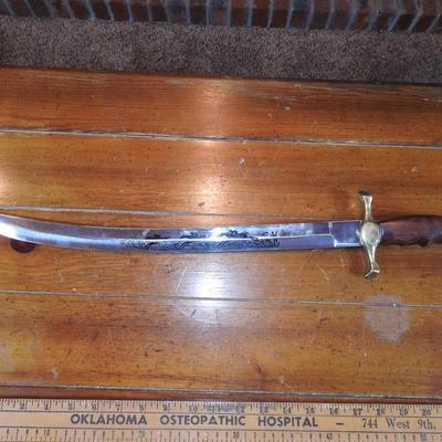 Sword in leather scabbard