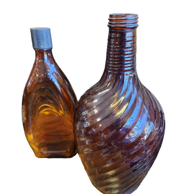 Two Brown/Amber Swirl Design Bottles