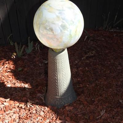 Gazing ball on concrete pedestal
