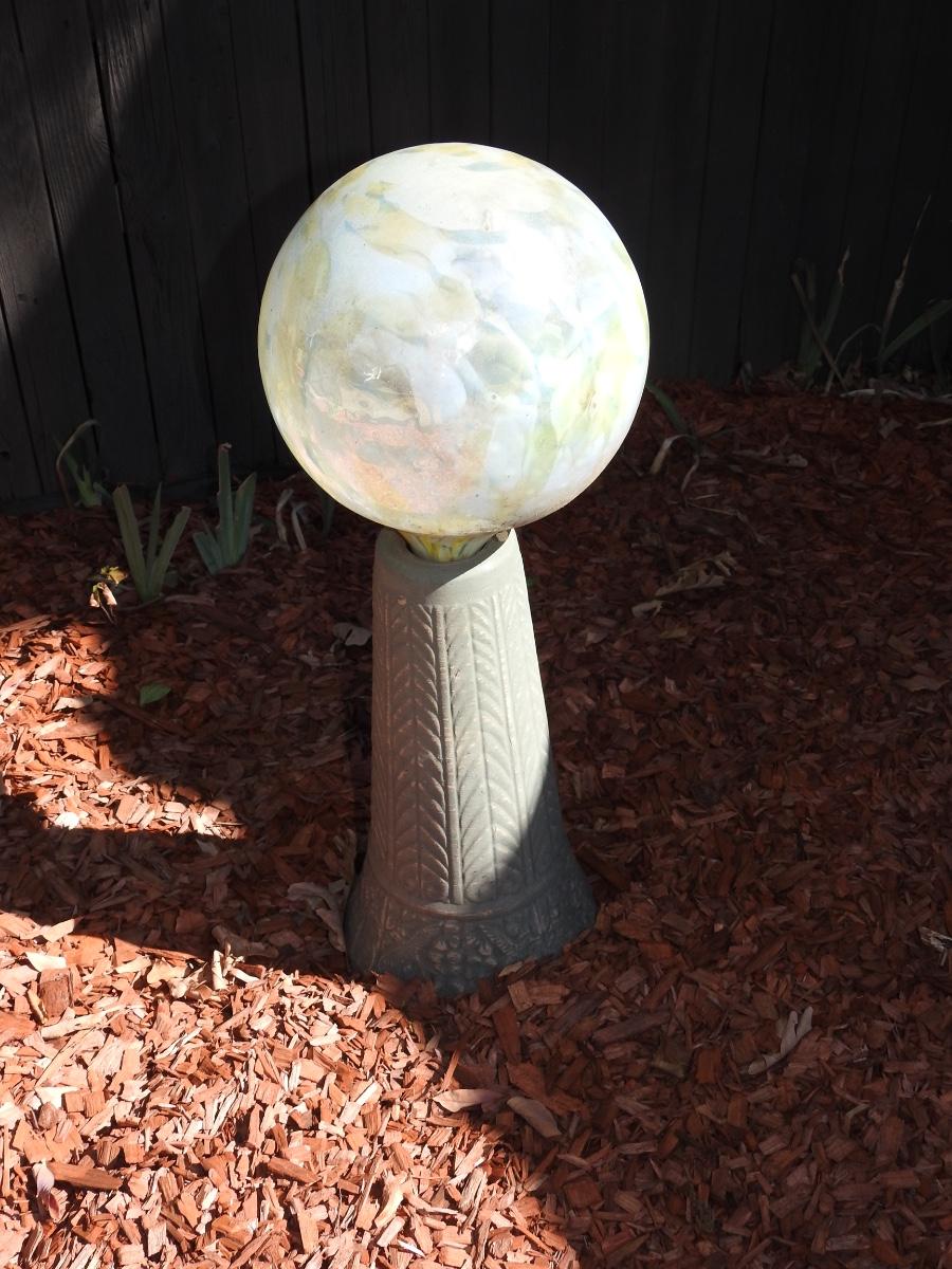 Gazing ball on concrete pedestal
