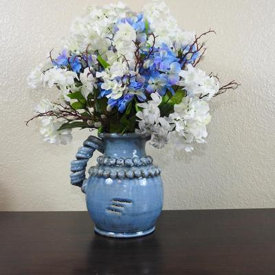 Blue pottery pitcher floral arrangement