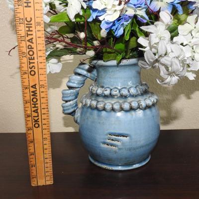 Blue pottery pitcher floral arrangement