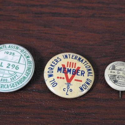 Collection of oil workers international union pins from the 1930s