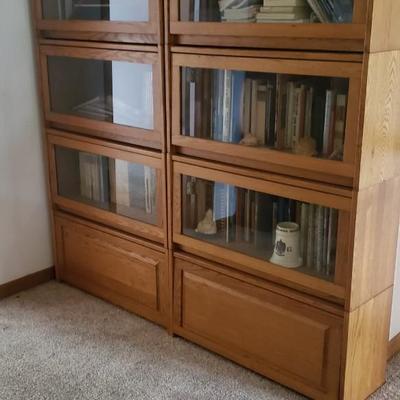 2 vintage large  bookcases with fold up glass doors.