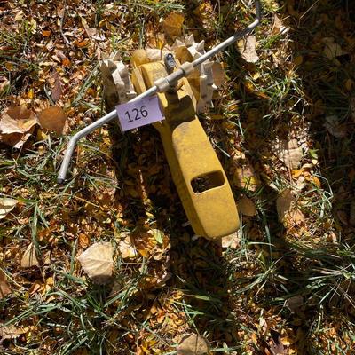 Yellow tractor lawn sprinkler