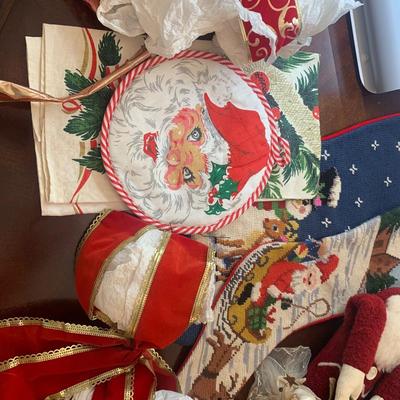 2 needlepoint stockings, bows, ribbon, brass horns, Santa