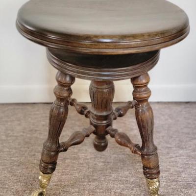 Antique piano stool with claw feet