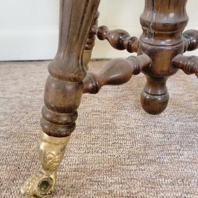Antique piano stool with claw feet
