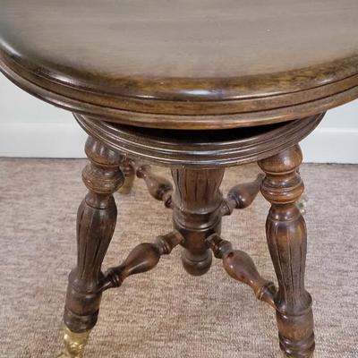 Antique piano stool with claw feet