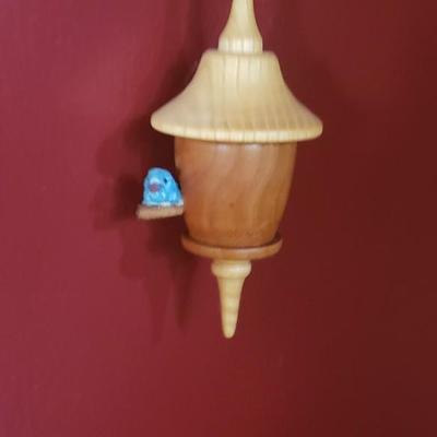 Wood bluebird on a spindle birdhouse