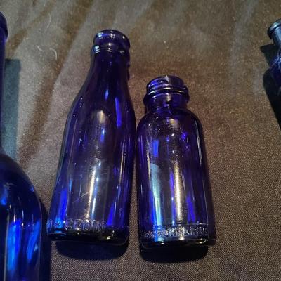 pair of (4) vintage glass bottles and pair of salt and pepper shakers
