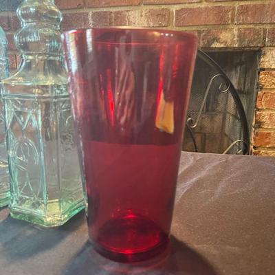 (3) vintage glass bottles, (1) red vase