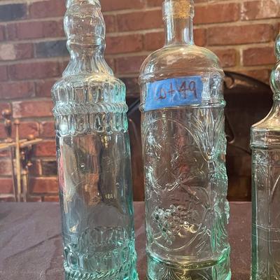 (3) vintage glass bottles, (1) red vase
