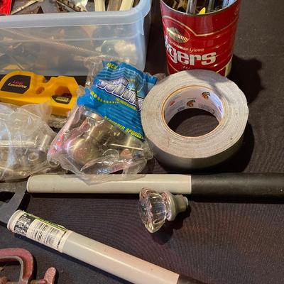 Plastic container, plastic tool carrier, antique misc. knobs, oil can, wrenches, pliers, locks, laserlevel pro, hole puncher, bag of...