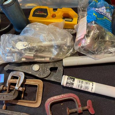 Plastic container, plastic tool carrier, antique misc. knobs, oil can, wrenches, pliers, locks, laserlevel pro, hole puncher, bag of...
