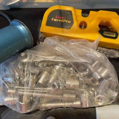 Plastic container, plastic tool carrier, antique misc. knobs, oil can, wrenches, pliers, locks, laserlevel pro, hole puncher, bag of...