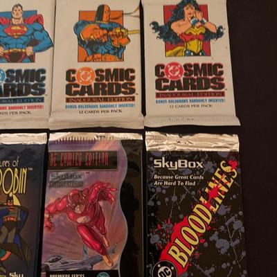 (4) DC cosmic cards inaugural edition, (4) Skybox DC comic cards.